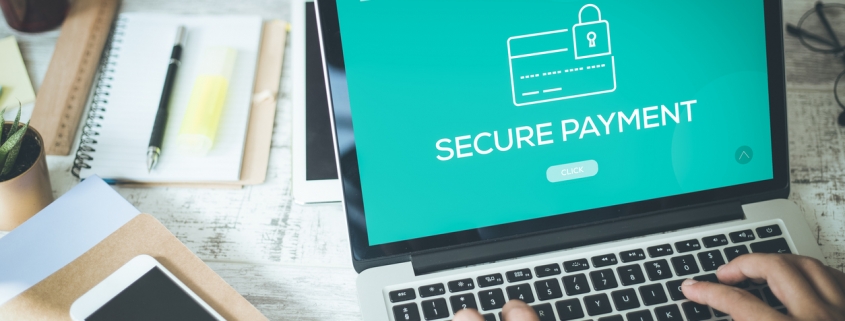 ACH secure payment concept; businessman doing an online transaction using a laptop